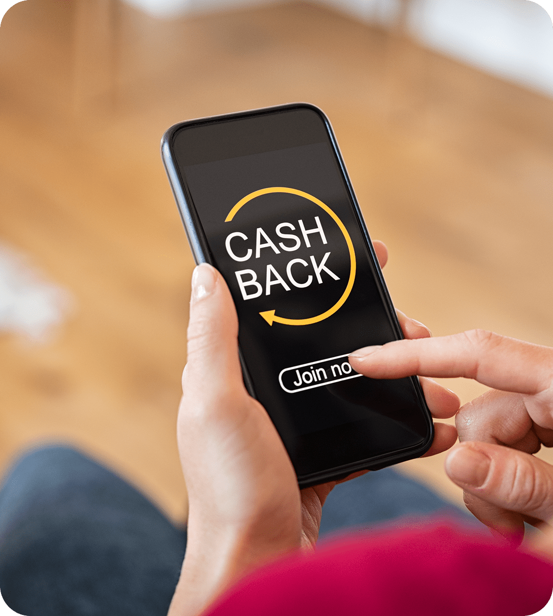 Person holding a smartphone displaying a "CASH BACK" offer with a "Join now" button on the screen.