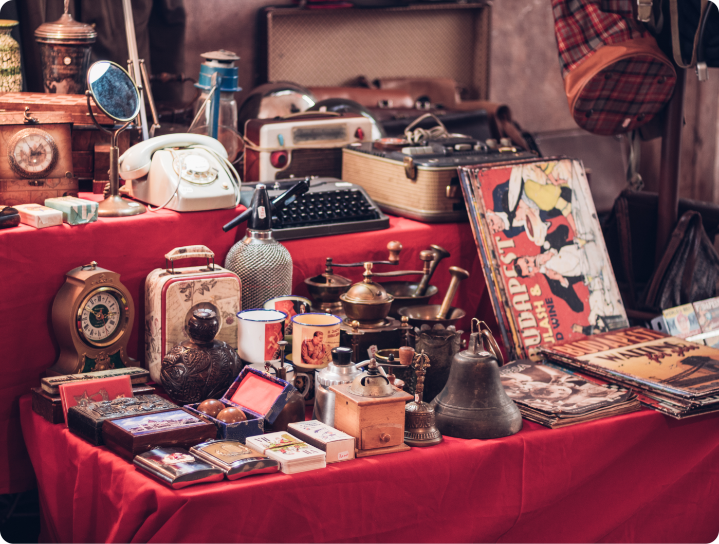 home1 (1) A table full of old items on top of red cloth.